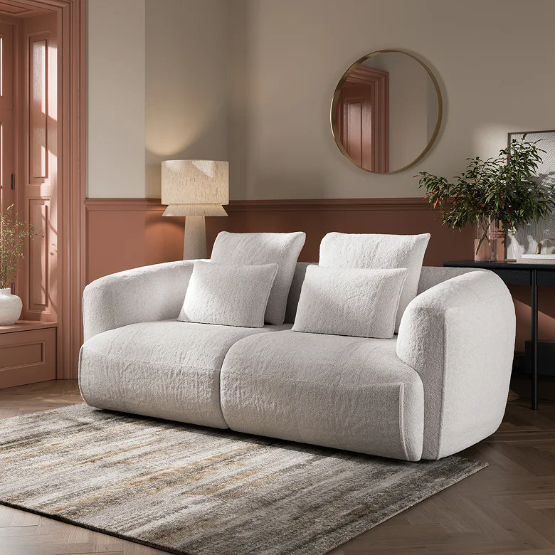 compact white curved boucle sofa in living room