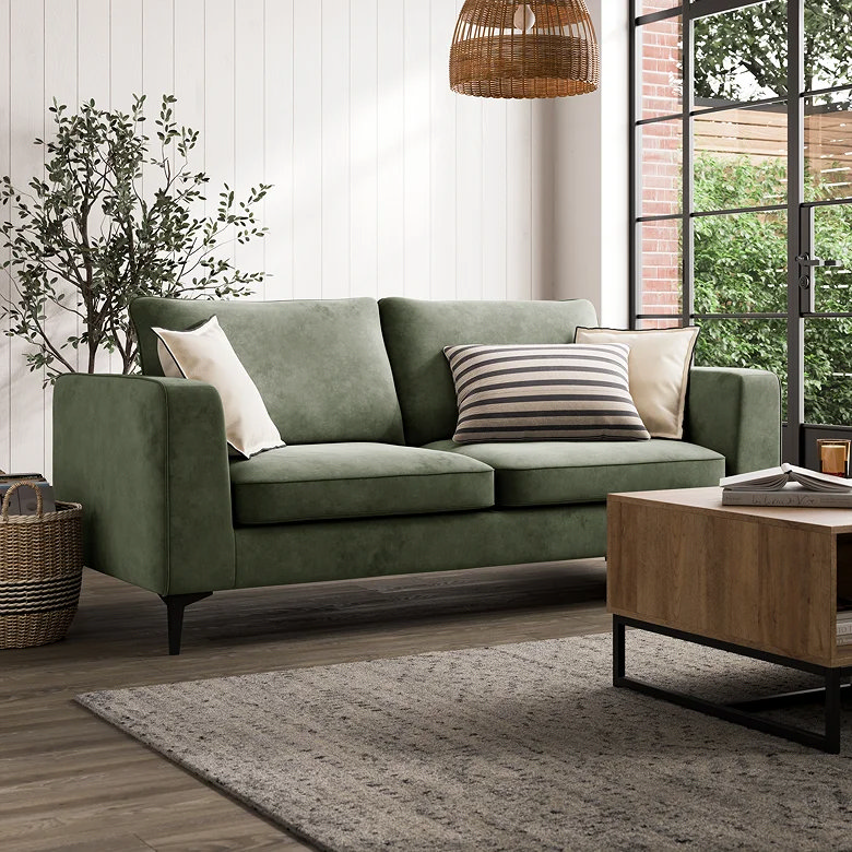 small sage green sofa in compact room