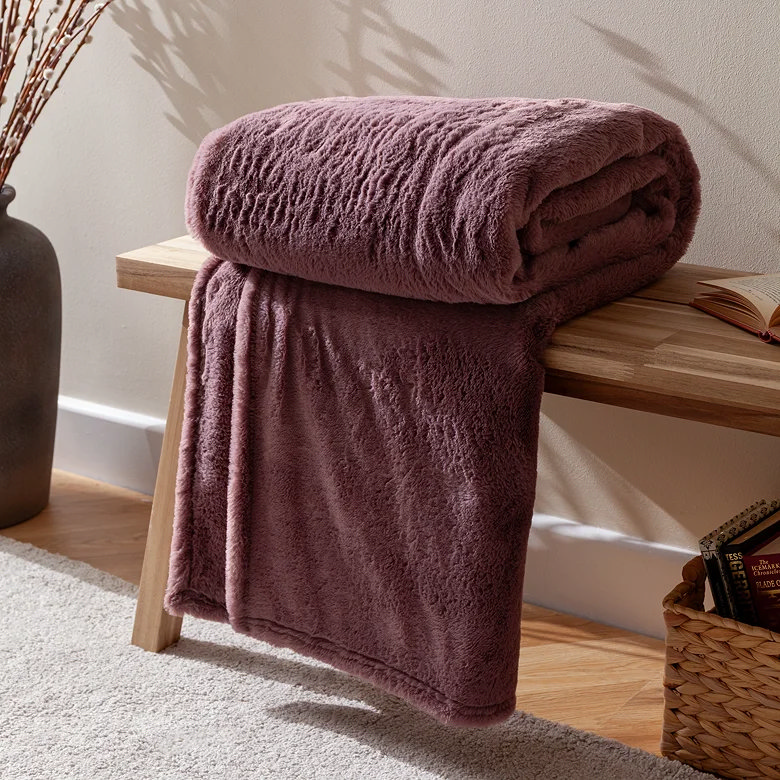 mulberry faux fur winter blanket on wooden bench