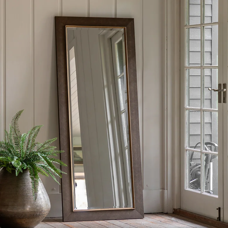 large wooden leaner mirror in study space