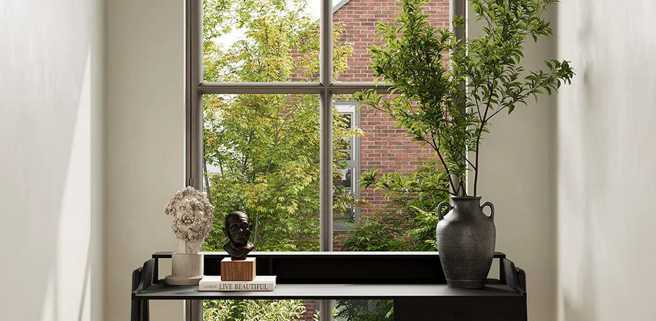 black console table decorated with plant and ornaments