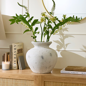 White Vase With Faux Plants In It