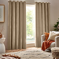 Cream Curtains with chair in front