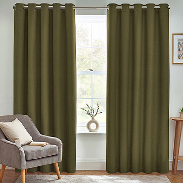 Green curtains with chair in front