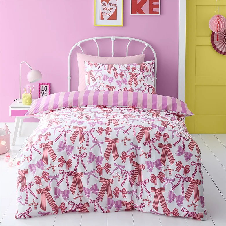 pink bow print duvet cover set with striped reverse in bright pink bedroom styling