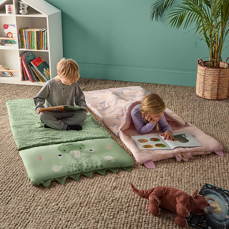 kids dinosaur and unicorn sleepover bags with padded mats for indoor play and reading