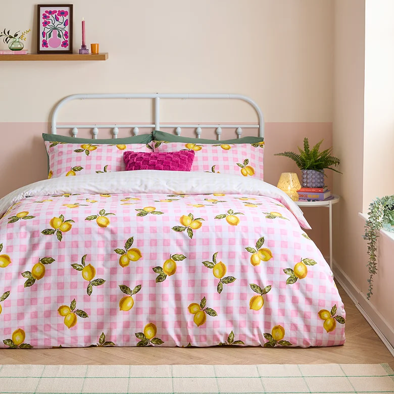 pink gingham lemon print duvet cover set styled in playful bedroom with bright cushions and soft pastel decor