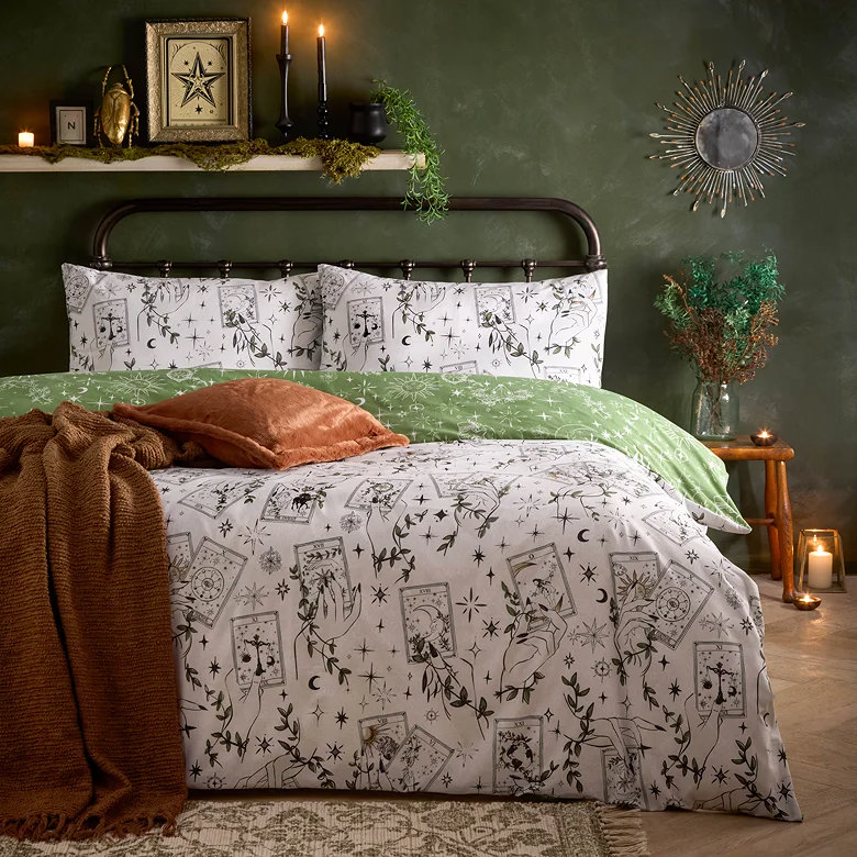 white and green patterned bedding with mystical tarot card and celestial design