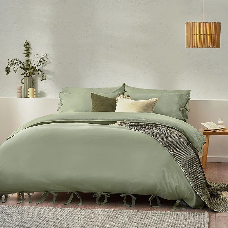 plain green bedding set with soft cotton finish and decorative tie fastening detail