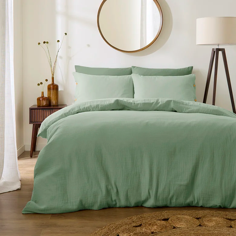 eucalyptus green muslin bedding with soft textured duvet cover in a relaxed natural bedroom