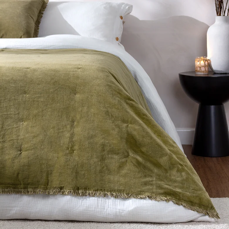 olive moss green quilted bedspread with fringed edge for a warm, cosy bedroom