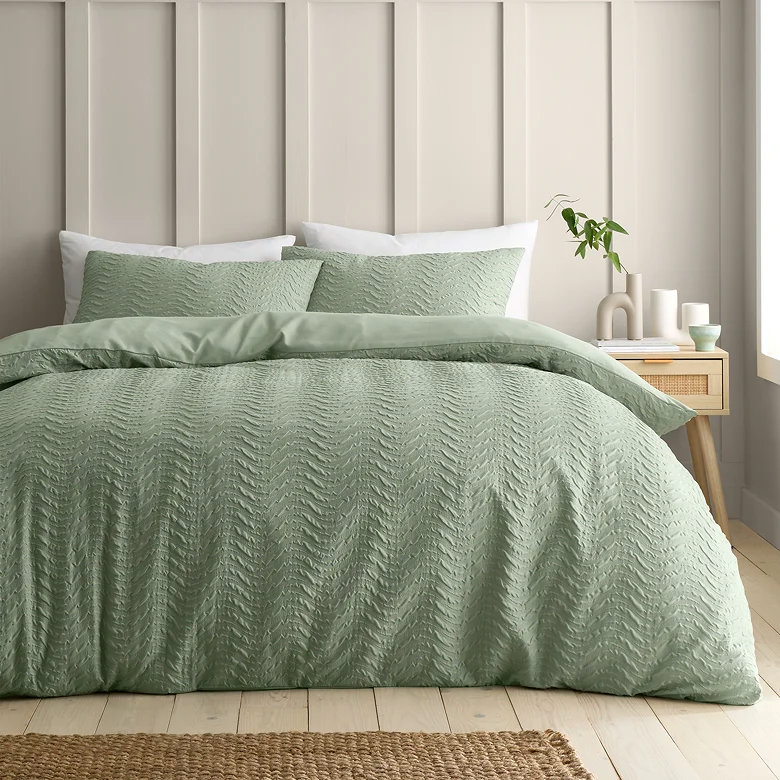 mint green textured duvet cover set with matching pillowcases in a light, airy bedroom