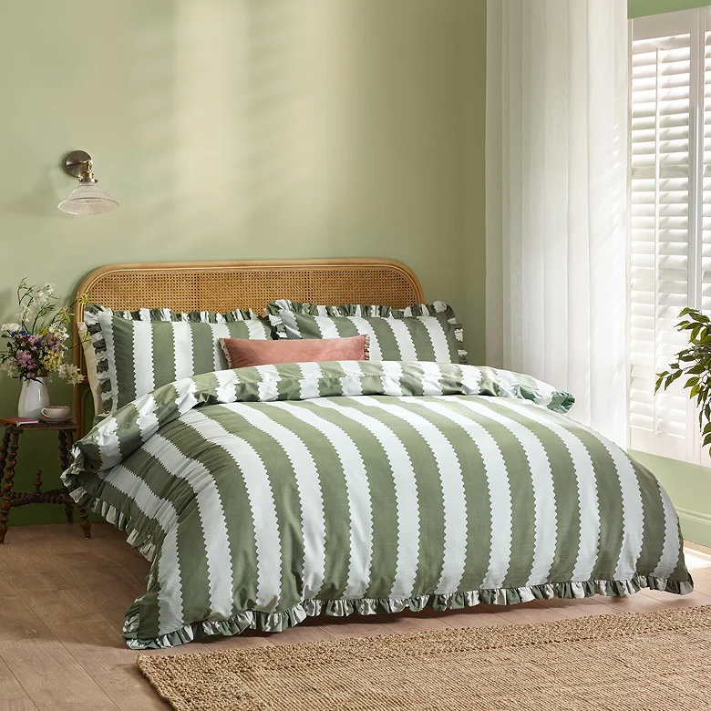 green striped duvet cover set with ruffle trim in soft sage bedroom