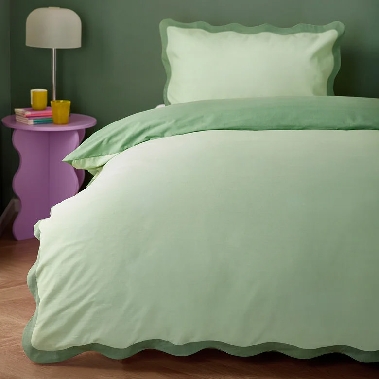 sage green duvet cover set with scalloped edge trim in bold modern bedroom