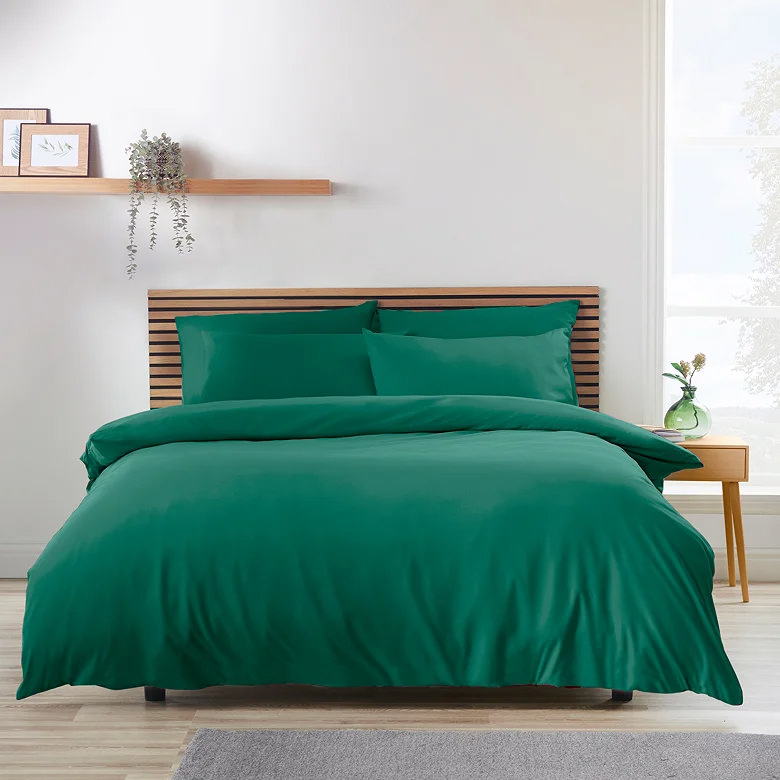 teal green duvet cover set with matching pillows and minimalist wooden bed frame