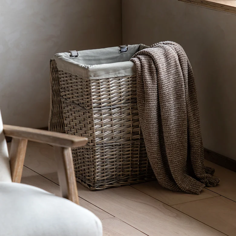 woven linen lined laundry basket in hallway