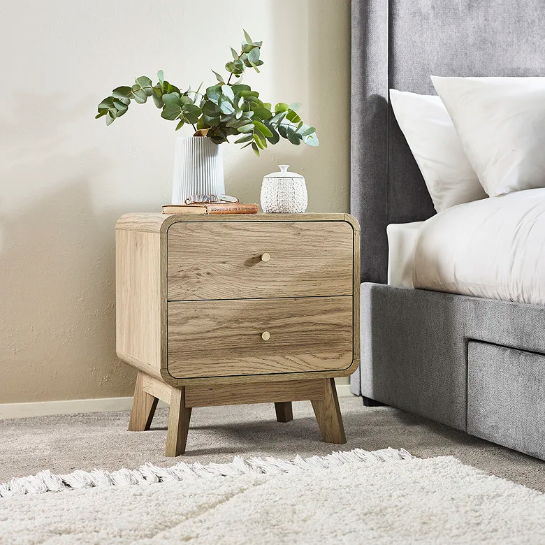 light wood bedside table with house plant