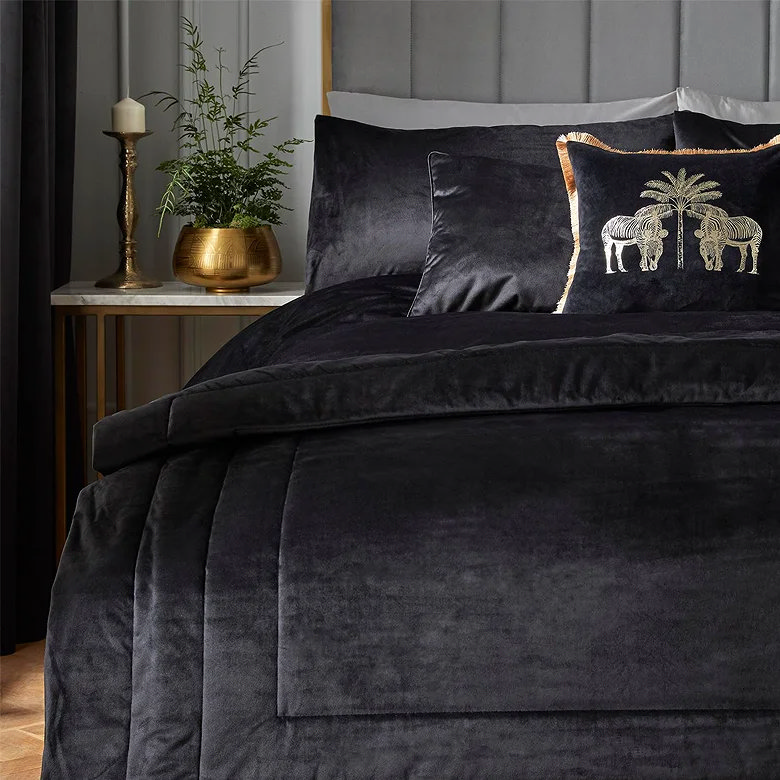 traditional candle on bedside table by black bedding