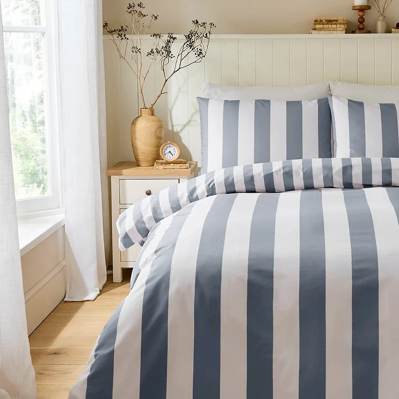 small alarm clock on bedside table with plant