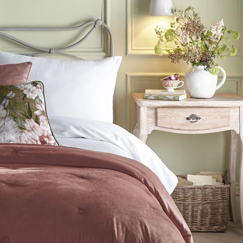 woven storage basket under light wood bedside table