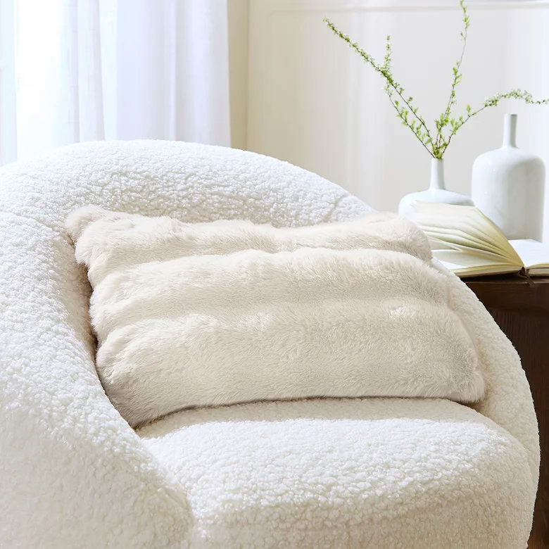 faux fur christmas pillow on fleece texture armchair