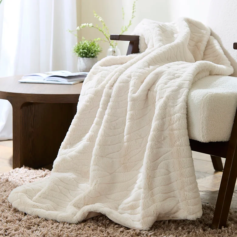 white faux fur throw over armchair