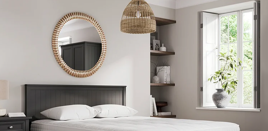 chunky wooden bedroom mirror above bed