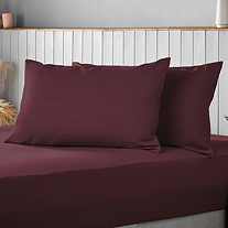 Burgundy Pillows on a bed