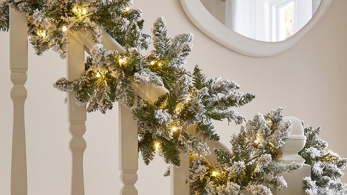 Lit up garland going down the stairs