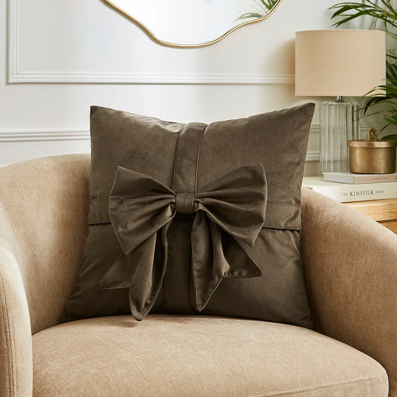 brown velvet bow cushion in home office