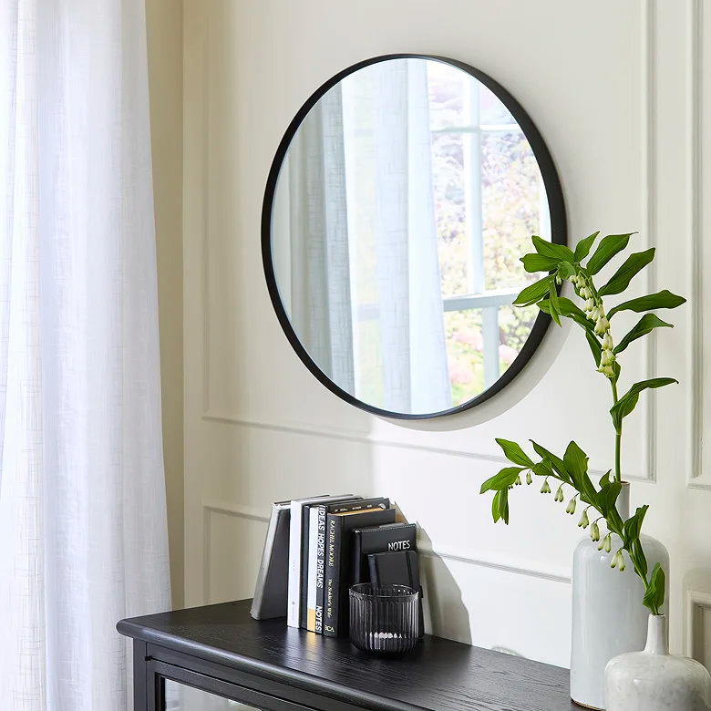 black round metallic mirror in home office