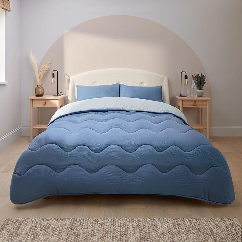 blue coverless duvet on fabric bed