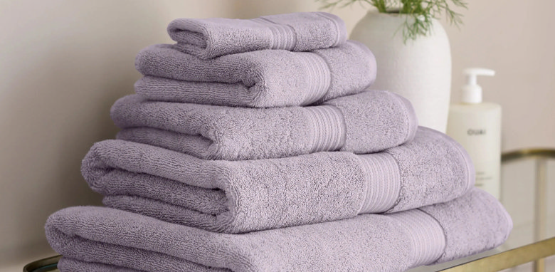 folded light purple towels in bathroom