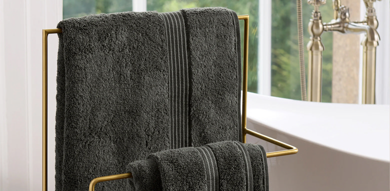 two black towels hung on a towel rack