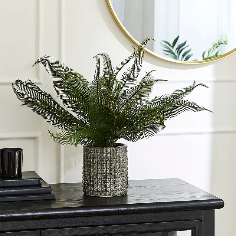 medium wide fern faux plant in bedroom