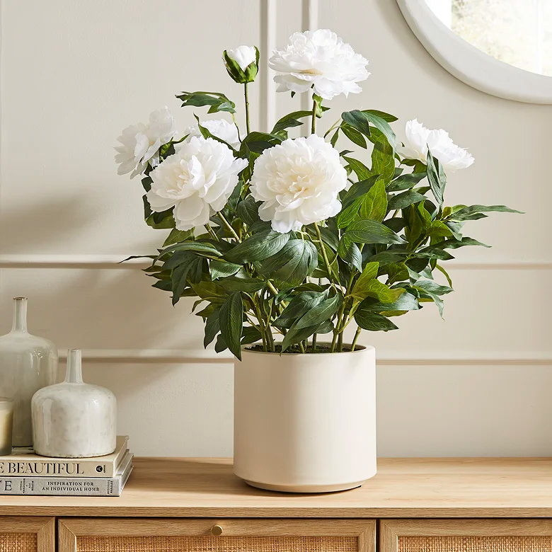 white peony faux flower in cosy bedroom