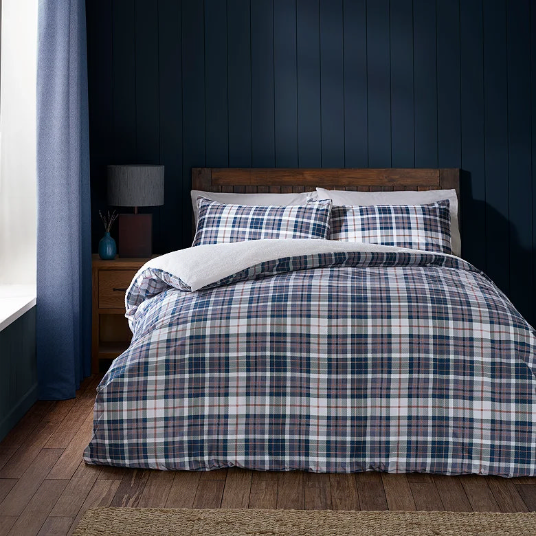 Navy check duvet set in a dark blue bedroom.