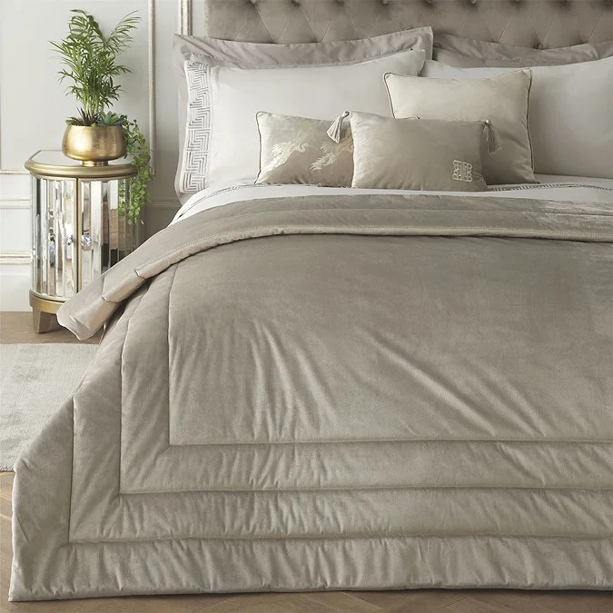 Taupe velvet bedspread layered over duvet