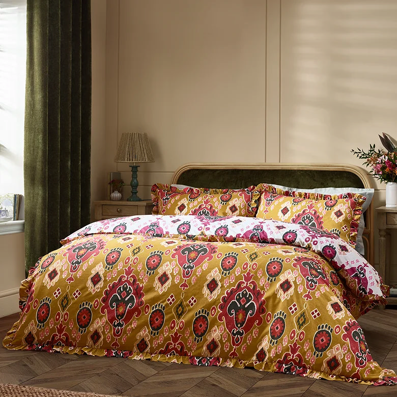 Ochre and red patterned duvet set in cosy bedroom.