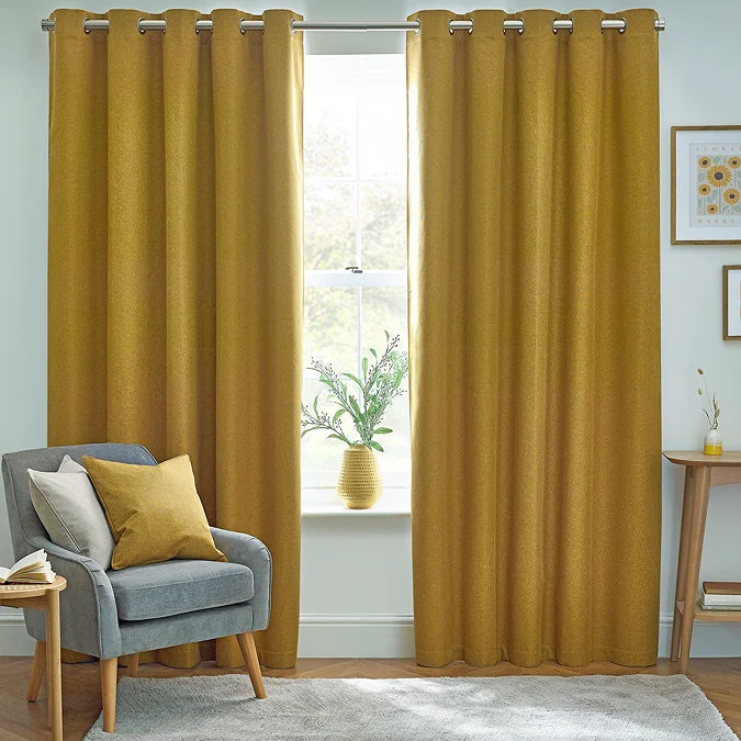 Butter yellow curtains adding warmth to a neutral living room.