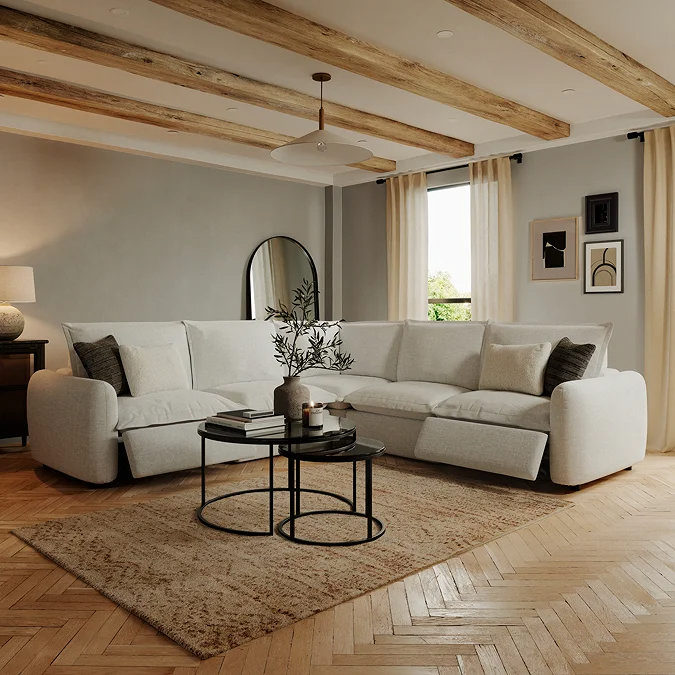 Cream L‑shaped corner sofa with nine neutral cushions in a three‑zone arrangement, illustrating balanced corner‑sofa cushion styling