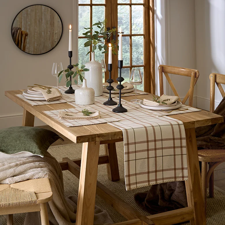 Dining room table decor with runner placemats candles and greenery