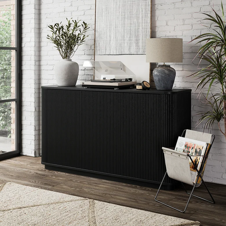 black fluted sideboard in earthy living room with natural textures and modern styling