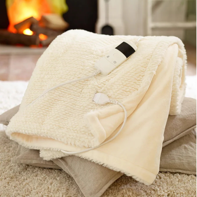 Cream heated throw with controller on cushions
