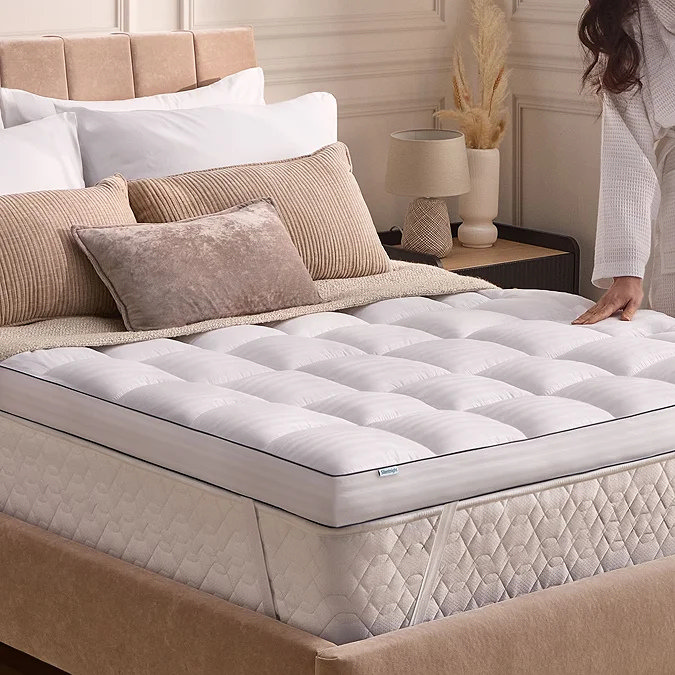 Quilted mattress topper on upholstered bed
