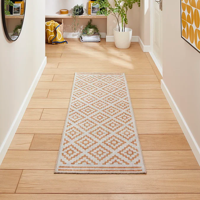 Butter yellow patterned runner warming a light, neutral hallway.