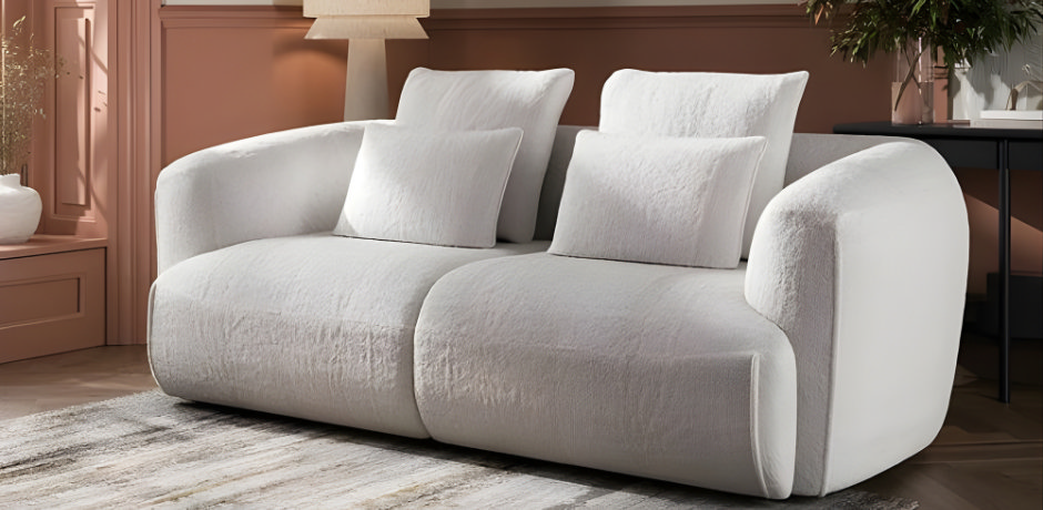 Freshly cleaned fabric sofa with plumped cushions in a tidy living room after spring cleaning