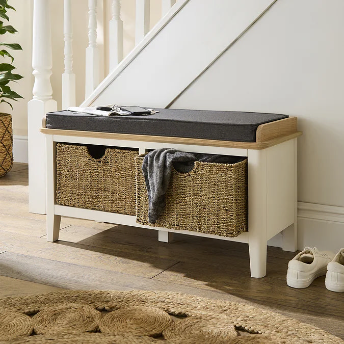 White wooden storage bench with woven baskets and cushioned seat, ideal for hallway or living room toy storage.