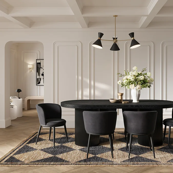 Black upholstered dining chairs paired with a black oval pedestal dining table in an elegant, panelled dining room.