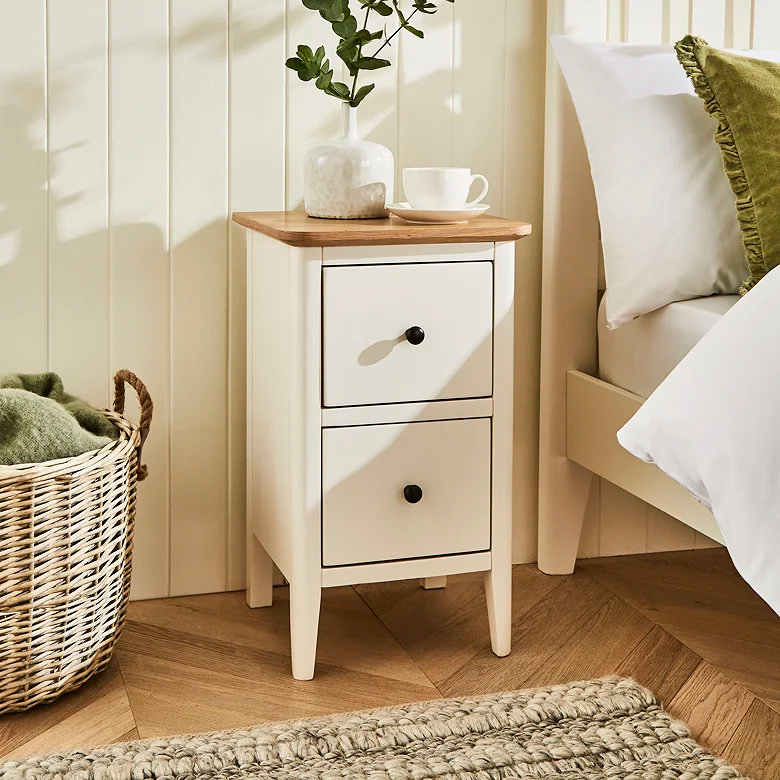 light bedroom with cream bedside cabinet, wooden top and simple drawer storage